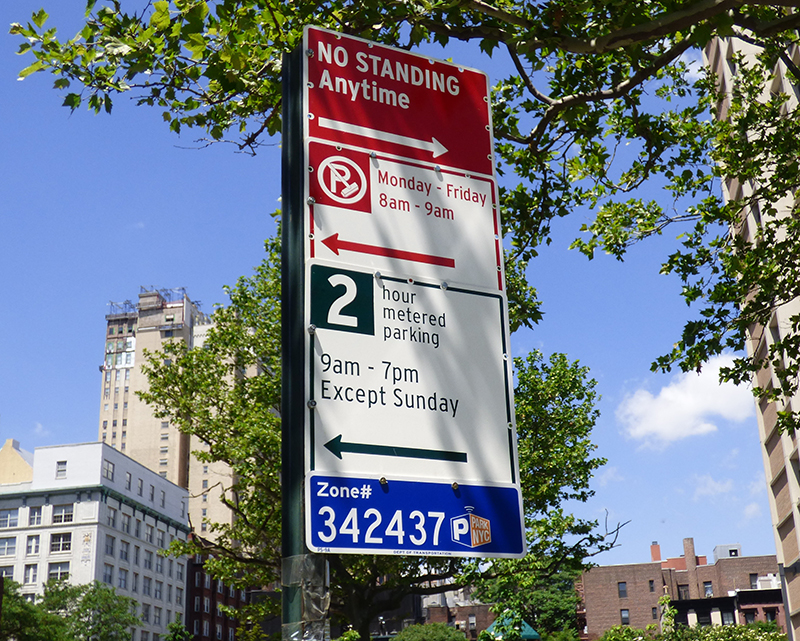 A new method to pay parking meters on city streets by using a smartphone app has rolled out in Brooklyn. Shown: Zone numbers now appear on parking signs at the end of each block. Photo by Mary Frost