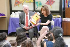 Jackie and Mike Bezos read to children and families at NYU Langone Hospital - Brooklyn. Photo courtesy of NYU Langone Hospital - Brooklyn