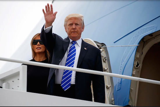 President Donald Trump, waving as he boards Air Force One with first lady Melania Trump for a trip to Poland and Germany on Wednesday, is now being brought into the race for mayor of New York City. AP Photo/Evan Vucci