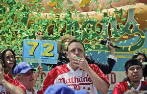 Claiming his record 10th victory, Joey Chestnut won the annual Nathan’s Famous Hot Dog Eating Contest on the 4th of July at the historic Coney Island Nathan’s. Green confetti rained down around him and sweat rolled down his face after he stuffed 72 hot dogs and buns into his stomach in 10 minutes. AP photo by Bebeto Matthews