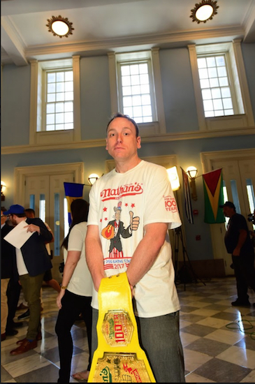 Champion Joey “Jaws” Chestnut holding a Mustard Belt. Eagle photos by Andy Katz