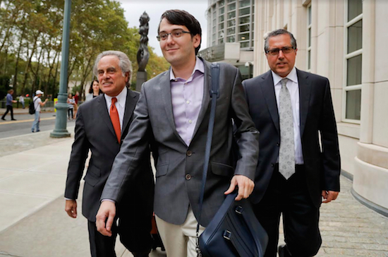 Former biotech CEO Martin Shkreli, center, leaves federal court with his attorney Benjamin Brafman, left, in Brooklyn. A jury began deliberations Monday at Shkreli's federal securities fraud trial. AP Photo/Julie Jacobson, File