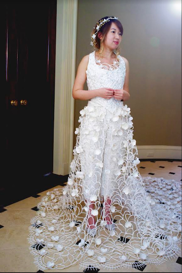 Van Tran models the wedding dress she created using toilet paper, glue, tape and a needle and thread. Photo courtesy of Cheap Chic Weddings/Quilted Northern