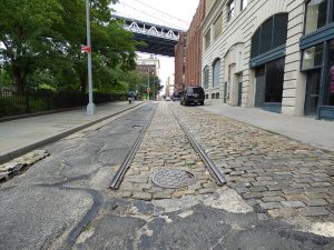 A new report issued by the Historic District Council outlines ways to preserve DUMBO’s unique Belgian block streets while complying with the mandate to make them assessable. Photo by Mary Frost