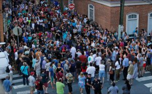 Several hundred mourners gather Sunday, Aug. 13 at the site where a car plowed into a crowd of people protesting a white nationalist rally on Saturday in Charlottesville, Va. AP Photo/Steve Helber