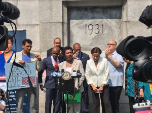 U.S. Rep. Yvette Clarke (at podium) says Confederate monuments at Fort Hamilton are “personal insult to the hundreds of thousands of women and men in Brooklyn who are descendants of a people held in bondage.” Photo courtesy of Clarke’s office