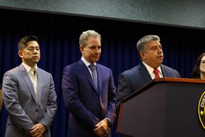 Acting Brooklyn District Attorney Eric Gonzalez calls for federal law enforcement to stop arrests in state courtrooms. Photo center: Attorney General Eric Schneiderman, left, Steven Choi of the New York Immigration Coalition. Eagle photos by Paul Frangipane