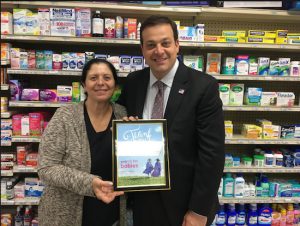 March of Dimes Brooklyn Committee  Co-Chairman John Quaglione presents Maria Georgakopoulos with certificate saluting the Bridge Pharmacy’s raising money for the March of Dimes. Eagle photos by John Alexander