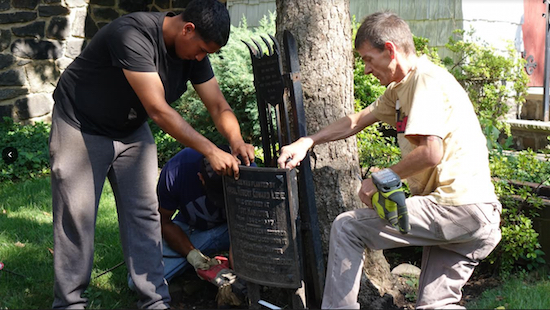 Crew working with the Episcopal Diocese of Long Island saw into one of the plaques commemorating Robert E. Lee. Photo: Episcopal Diocese of Long Island. Photos: Episcopal Diocese of Long Island.