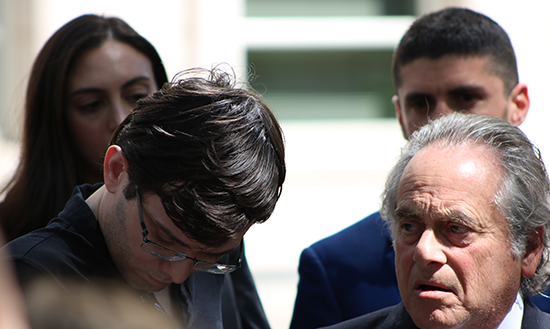 Martin Shkreli hangs his head outside Brooklyn federal court after he was convicted of security fraud. Photo right: Shkreli's laywer, Benjamin Brafman. Eagle photos by Paul Frangipane.