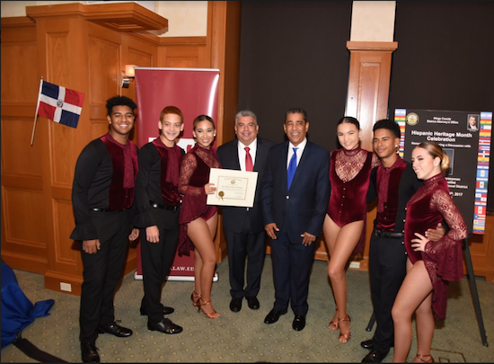 Acting DA Eric Gonzalez (in red tie) poses with Rep. Adriano Espaillat (blue tie) and dancers from the Elite Stars Dance Academy. Photos courtesy of the Brooklyn DA’s Office