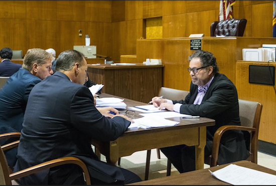 Judge George J. Silver (right), deputy chief administrative judge for the NYC Courts, sits with attorneys from AmTrust Financial to work to try to settle cases to avoid backlogging in the courts. Eagle photo by Rob Abruzzese