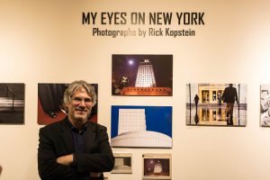 Photographer Rick Kopstein in front of part of his exhibit, “My Eyes on New York,” in the Charles P. Sifton Gallery at Brooklyn’s federal court. Eagle photos by Paul Frangipane.