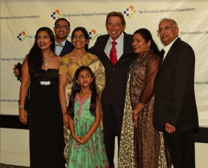 Retired NY Jets Hall of Famer Joe Namath poses with TBHC Walter Reed Medal Honoree Dr Saimamba Veeramachaneni (3rd from left in glasses) and family. Eagle photos by Andy Katz