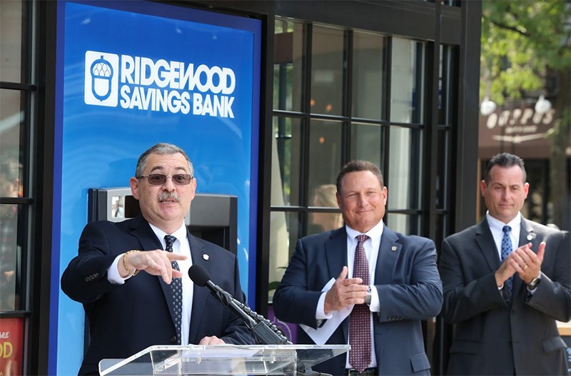 Ridgewood Bank President and COO Leonard Stekol (left) addresses crowd at banks grand opening ceremony, with Chairman and CEO Peter Boger and Executive Vice President & Chief Lending Officer Anthony J. Simeone.