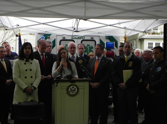 Jacqui Lopez (at podium), whose husband, Luis Lopez died as a result of working on the recovery effort at the World Trade Center site, speaks about the importance of renewing the Det. James Zadroga Act at a press conference held by U.S. Reps. Dan Donovan and Peter King in Bay Ridge in 2015. Eagle file photo by Paula Katinas