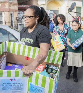 Students from the Bedford-Stuyvesant New Beginnings Charter School load emergency supplies onto vans to be sent to Puerto Rico. Photo courtesy of the New York City Charter School Center