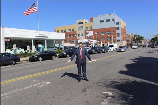 John Quaglione stands in the middle of Fourth Avenue where the paint on a “School Crossing” marking has faded away. Photo courtesy of Quaglione campaign