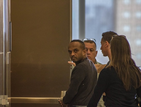 Ravin Lakhram, accused of stealing from a family in a mortgage scheme, being escorted by police officers into a Brooklyn Supreme Courtroom. Eagle photo by Paul Frangipane