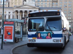 According to a report released by Comptroller Scott Stringer, city buses are glacially slow and are failing to transport Brooklynites to new jobs. Above, a bus near Brooklyn Borough Hall. Photo by Mary Frost