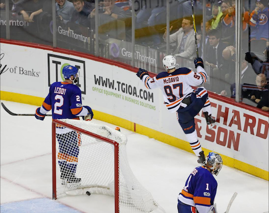 Goaltender Thomas Greiss and defenseman Nick Leddy can only watch in anguish Tuesday night as Edmonton superstar Connor McDavid celebrated his game-winning goal in overtime. AP photo by Kathy Willens