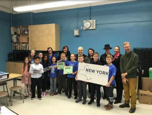Assemblymember Joe Lentol and Laura Perloff, a representative of the Pharmaceutical Research and Manufacturers of America, help students and educators at P.S. 34 celebrate the STEM grant. Photo courtesy of Lentol’s office