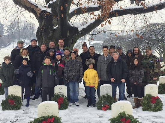 Members of Viking Love NYC stand before gravestones decorated with wreaths. Photo courtesy of Viking Love NYC