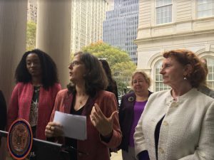 State Assemblymember Jo Anne Simon (right) listens as Councilmember Helen Rosenthal (center) pays tribute to pioneers in the women’s suffrage movement. At left is Chika Onyejiukwa, chairperson of the NYC Women Vote 100 Coalition. Photo courtesy of Rosenthal’s office
