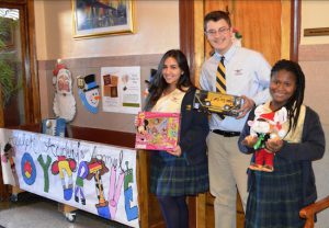 Student Advisory Board members Regina Levy, Arber Kadiu and Ania John (left to right) display some of the many toys that were donated to the school’s Holiday Toy Drive. Photos courtesy of Adelphi Academy of Brooklyn