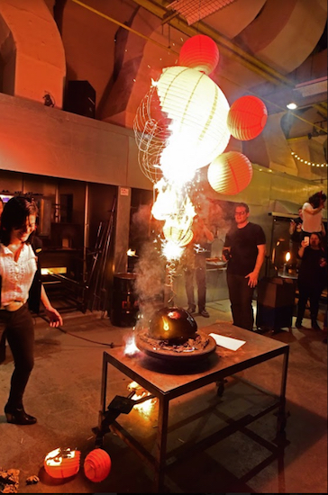 Paper globes burn while people sing “Happy Birthday.” Eagle photos by Andy Katz