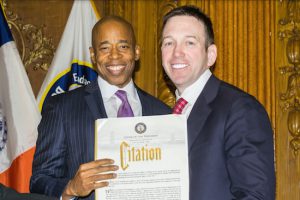 Borough President Eric Adams presents Hon. Andrew Borrok with a citation during his installation to the Brooklyn Supreme Court. Eagle photos by Rob Abruzzese