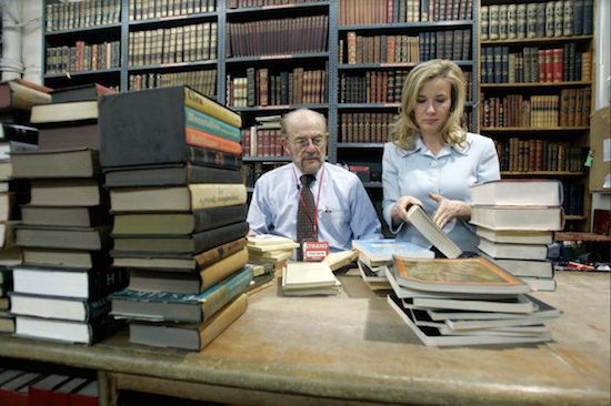 In this Feb. 21, 2007 file photo, Fred Bass sorts out a batch of used books with his daughter Nancy Bass Wyden in New York. AP Photo/Mary Altaffer