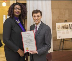 Helen Keller Services CEO Joseph Bruno accepts a citation from Jennifer Viechweg-Horsford, community liaison to state Sen. Roxanne Persaud at a ceremony marking the non-profit organization’s 125th anniversary. Photo courtesy of Helen Keller Services for the Blind