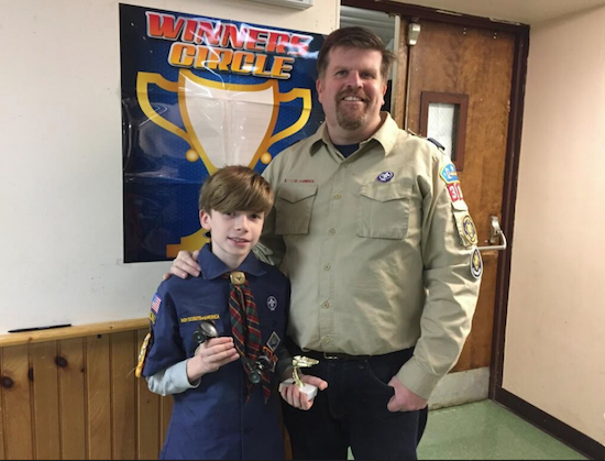 Cub Scout Pack 313 Cubmaster Paul Muccigrosso with his son David holding his trophy for winning the derby. Photo courtesy of Paul Muccigrosso