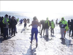 Swimmers descend into the Coney Island surf for a frigid New Year’s Day tradition. Eagle photos by Arthur De Gaeta