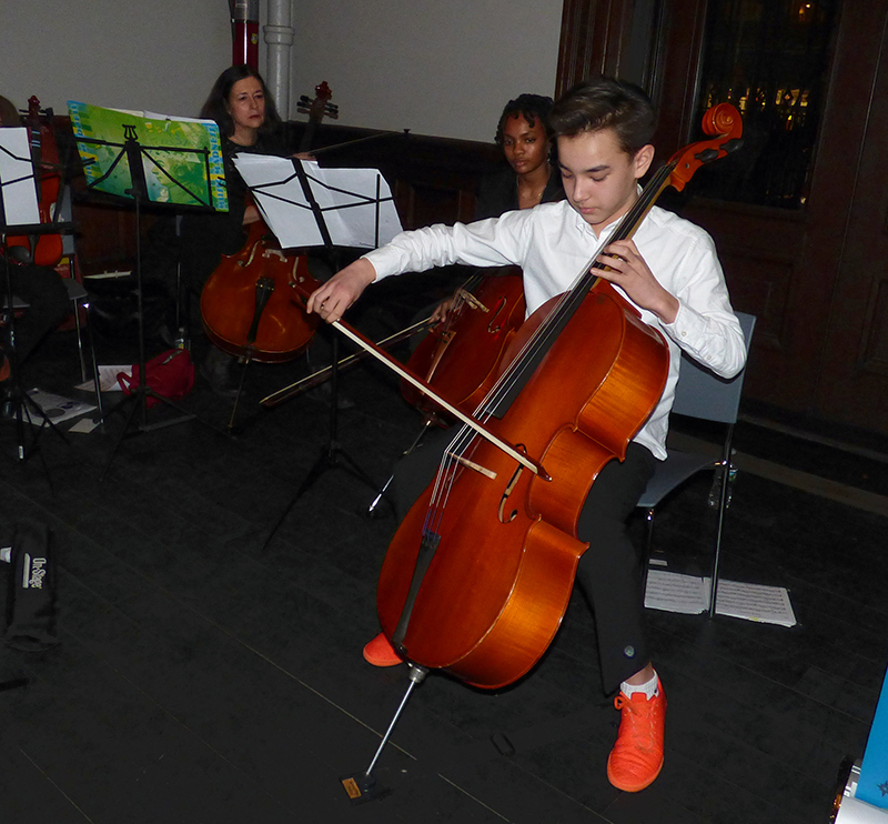 Members of the Middle School Chamber Orchestra entertained at Friday’s celebration. Shown playing is Breyten Neill, accompanied by chamber teacher Elvira Sullivan and high school student Maya Holtham. Eagle photo by Mary Frost