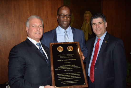 Chief Clerk Charles Small (center), of the Kings County Supreme Court, Civil Term, was honored by the Catholic Lawyers Guild on Tuesday for his contributions to the Brooklyn legal community. Also pictured are Gregory Cerchione (left) and Dominic Famulari (right), president of the Catholic Lawyers Guild. Eagle photos by Rob Abruzzese
