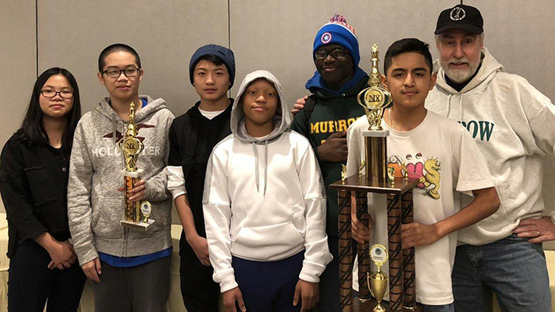 The chess team at Brooklyn’s Edward R. Murrow High School is getting ready to go to the state chess championships, where the school hopes to reclaim the NYS title. From left: Samantha Dong, Steven Xue, Wang Chan, Justin Dalhouse, Marcus Sutton, Anthony Saquisili and coach Eliot Weiss. Photo courtesy Edward R. Murrow HS