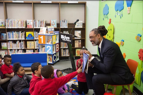 Councilmember Robert Cornegy Jr. had fun at the reopening reading to a group of local school children. Photo by Fritzi Bodenheimer/Brooklyn Public Library