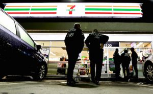 In this file photo from Jan. 10, U.S. Immigration and Customs Enforcement (ICE) agents serve an employment audit notice at a 7-Eleven store in Los Angeles. Lawmakers in New York City are seeking to ban ICE agents from making arrests in court houses. AP Photo/Chris Carlson/File