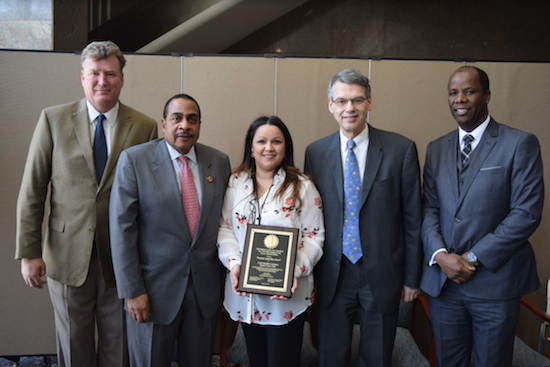 Lori Juarbe-Casiano (center holding plaque) was named Employee of the Year, 2018 Court Clerk of the Year during a ceremony in the lobby of the NYS Supreme Court, Civil Term, on Tuesday. Pictured from left to right: Hon. Bernard Graham, Hon. Larry Martin, Lori Juarbe-Casiano, Hon. Lawrence Knipel, and Chief Clerk Charles Small. Eagle photos by Rob Abruzzese