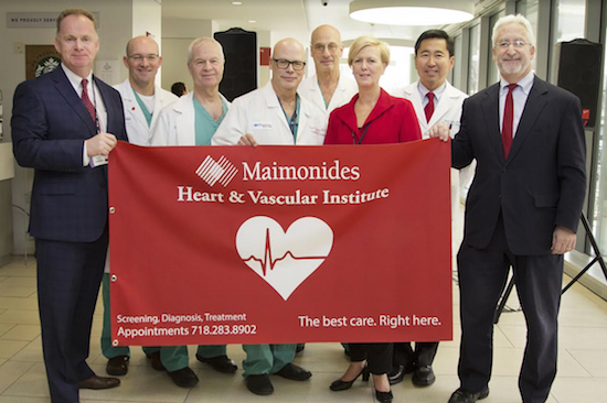 Maimonides Medical Center CEO Kenneth D. Gibbs (far right) helped present the flag. Pictured with Gibbs are (left to right) Senior VP of Operations Declan Doyle; Anesthesiology Vice Chair Dr. Mark Kronenfeld; Cardiology Chair Dr. Jacob Shani; Cardiothoracic Surgery Director Dr. Greg Ribakove; Anesthesiology Chair Dr. Steven Konstadt; Heart and Vascular Institute Assistant VP Lorraine Carroll; and Vascular Surgery Chief Dr. Robert Rhee. Photo courtesy of Maimonides Medical Center