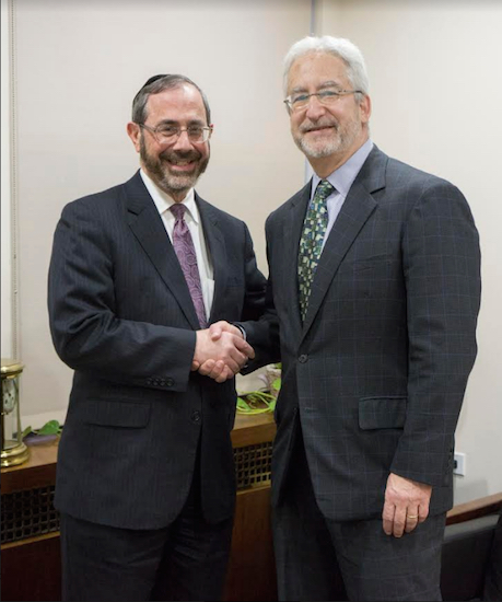 Barry Stern (left), president and CEO of New York Community Hospital, and Kenneth Gibbs, his counterpart at Maimonides Medical Center, shake hands to seal the agreement. Photo courtesy of Maimonides Medical Center