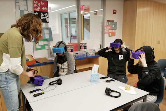 In this Feb. 7 photo, Lily Adler, left, adviser and teacher at the Berkeley Carroll School, adjusts her virtual reality headset. Experts say the technology is still relatively rare in schools, but they expect that to change as costs come down and content improves. From center left are students, Daniel Cornicello, 17, Charlie Hertz, 17, and Taylor Engler, 16. AP Photo/Deepti Hajela