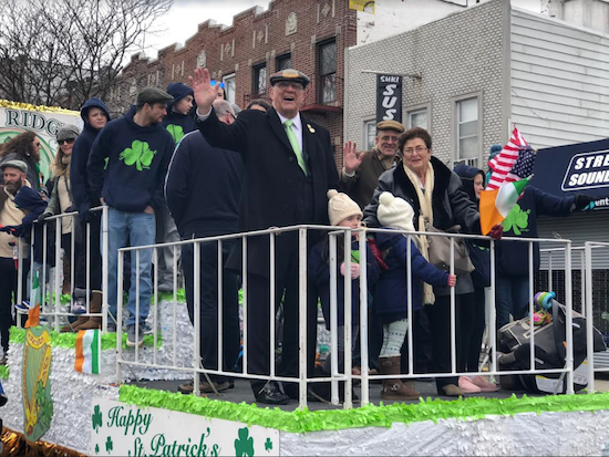Surrounded by children and grandchildren, Mike and Eileen Long ride the parade route aboard a float as the Irish Family of the Year. Eagle photo by Paula Katinas