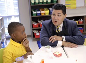 Houston Independent School District Superintendent Richard Carranza, appointed by Mayor Bill de Blasio as the new chancellor of New York City schools, is shown talking with Houston second grader John Bradford, 7, following Hurricane Harvey.  AP file photo by David J. Phillip