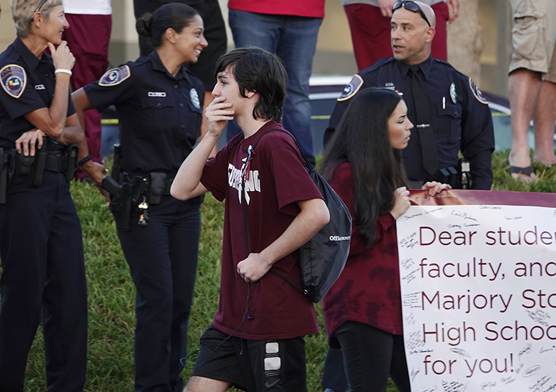 Hundreds of students across Brooklyn will be walking out of school at 10 a.m. Wednesday to protest gun violence. Shown: A returning student reacts as he walks to Marjory Stoneman Douglas High School in Parkland, Fla., Wednesday, Feb. 28, as classes resumed for the first time since students and teachers were gunned down in a February massacre. Photo by Joe Cavaretta/South Florida Sun-Sentinel via AP