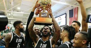 LIU-Brooklyn senior Joel Hernandez hoists the NEC Tournament championship trophy following the Blackbirds’ upset win over Wagner Tuesday night in Staten Island. Photo courtesy of Northeastconference.org