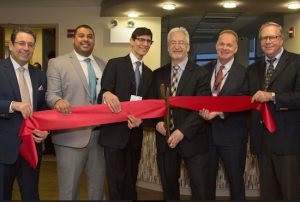 Doctors and officials from Maimonides Medical Center cut the ribbon to mark the opening of the new Spine Center. Pictured left to right are: Chairman of Orthopedics Dr. Jack Choueka; Orthopedic Spine Surgeon Dr. Ahmed Saleh; Director of Spinal Neurosurgery and Neurotrauma Dr. John Houten; Maimonides President and CEO Kenneth Gibbs; Senior VP of Operations and Clinical Programs Declan Doyle; and Chairman of Surgery Dr. Patrick Borgen. Photo courtesy of Maimonides Medical Center
