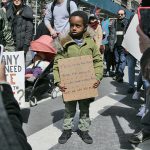 A child holds a sign reading, "This is my fourth march and I'm only 5. Kids have a voice too. And we say no more," at Saturday’s March For Our Lives gun control rally in Manhattan. Photo courtesy of Michael Campina